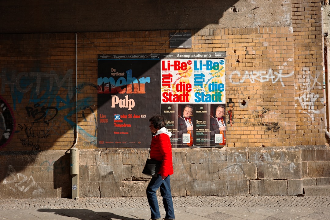 Posters layered on a brick wall